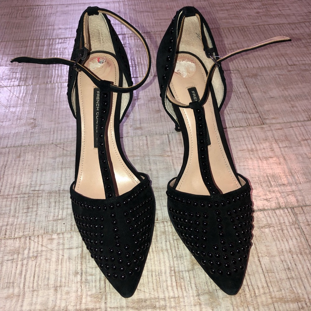 Black suede pumps with beaded detail.